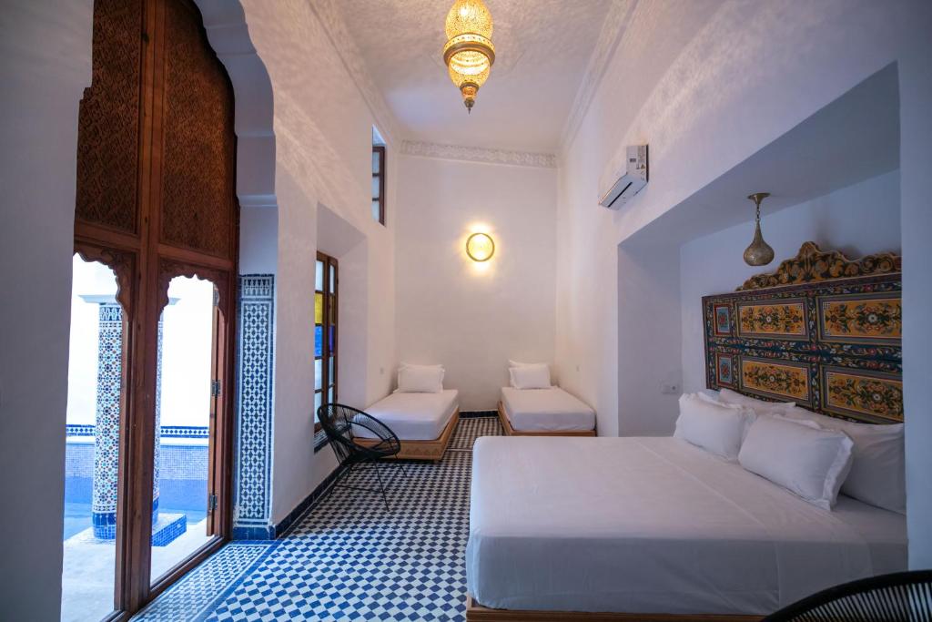 Postel nebo postele na pokoji v ubytování Riad Old City Palace