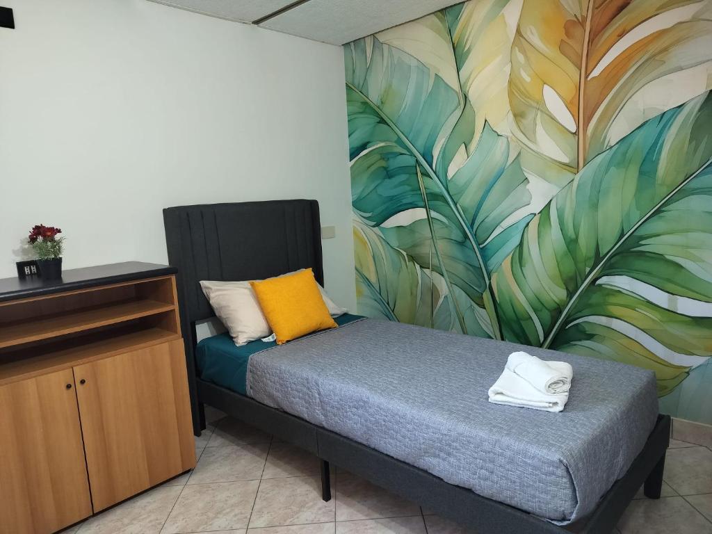 a room with a bed with a mural on the wall at Cozy Apartments in Lido di Ostia
