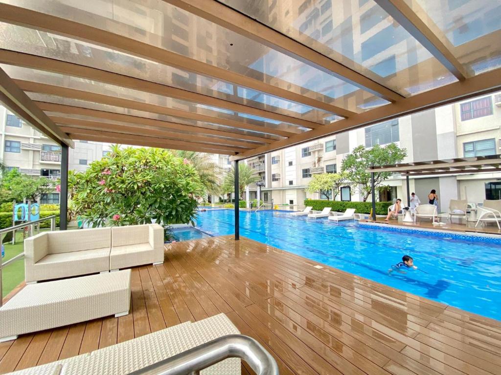a large swimming pool in a building with a building at Luxurious condo with City View in Cebu City