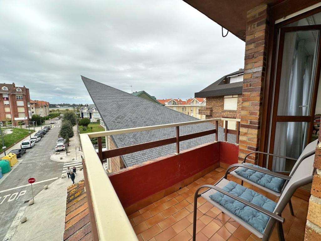a balcony with a bench on top of a building at La Espina, en Somo - 30024 in Somo
