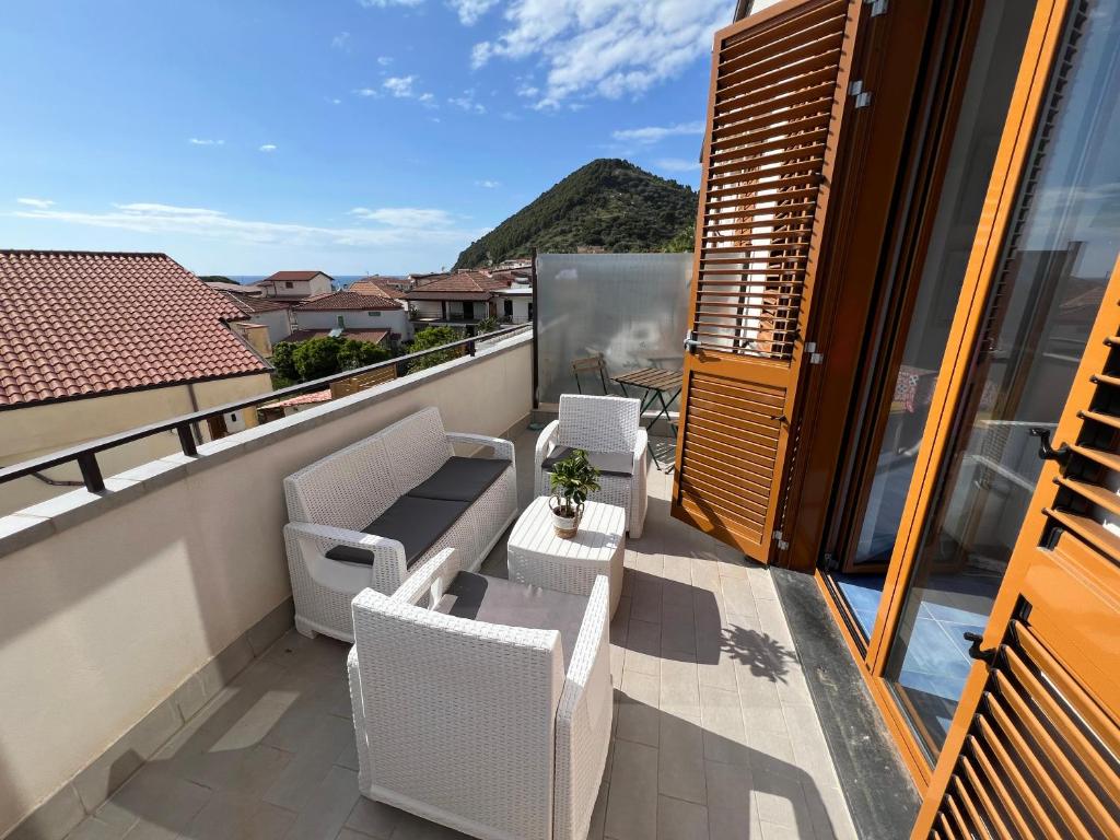 ein Balkon mit Stühlen und einem Tisch und einer Aussicht in der Unterkunft EDRI Punta Tresino a Castellabate in Santa Maria di Castellabate