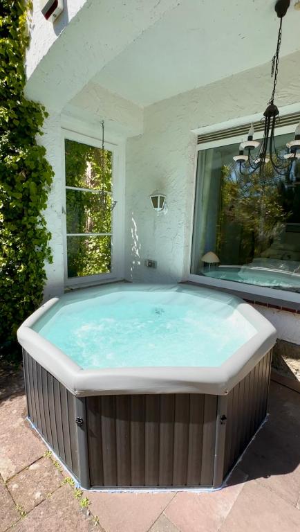 a jacuzzi tub in a backyard at Beheizter Whirlpool und Panoramafenster vom Bett ins Grüne! in Kassel