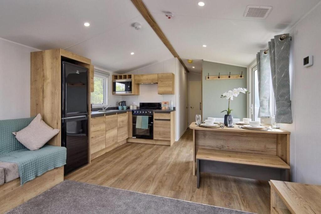 a kitchen and living room with a couch and a table at Seaside Caravan in Eyemouth in Eyemouth