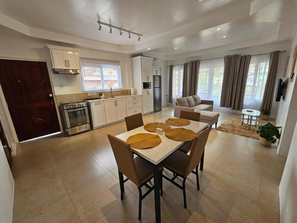 a kitchen and living room with a table and chairs at Agape Suites-Room 3- 1st Floor in Soufrière