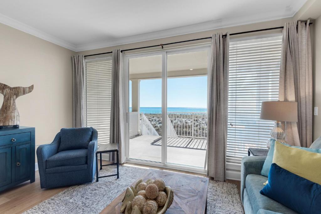 a living room with a view of the ocean at Beach Baby by Gulf Coast Getaways in Navarre