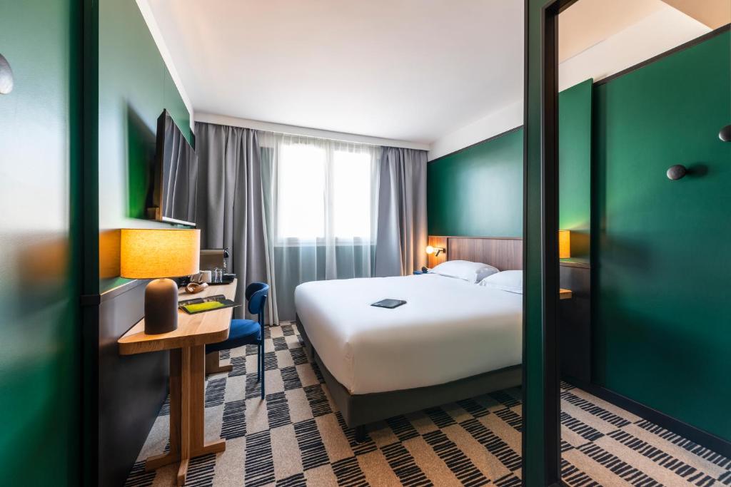 Postel nebo postele na pokoji v ubytování Hotel Le Lumière