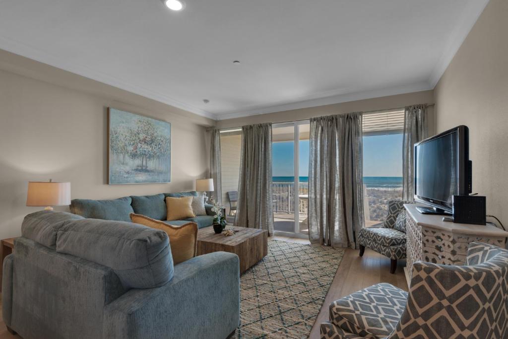 a living room with a couch and a television at Bikini Bottom by Gulf Coast Getaways in Navarre