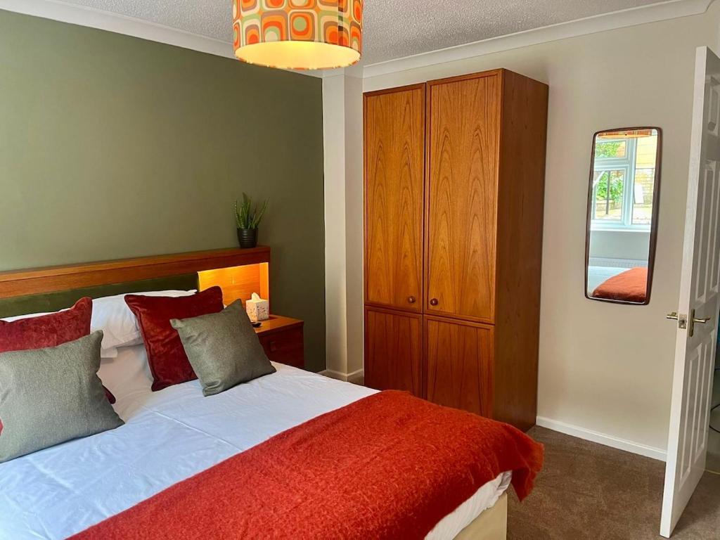 a bedroom with a large bed with a red blanket at Vintage Vibes in Weston-super-Mare