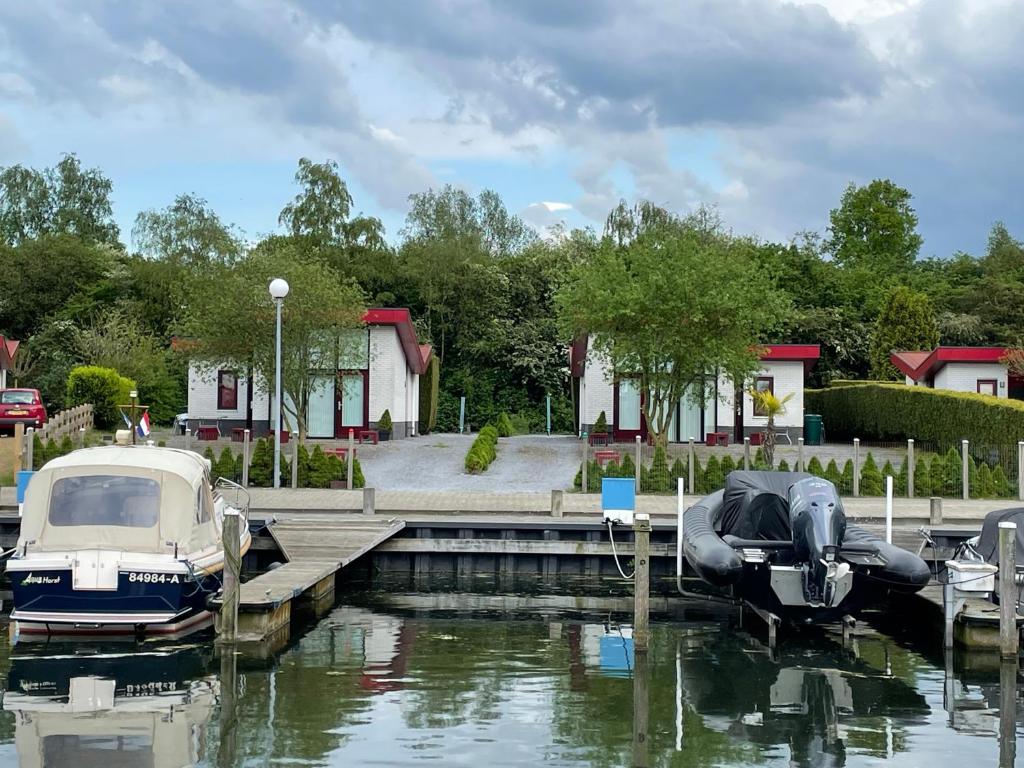 a couple of boats docked at a dock at Vakantiehuis Atthis in Ermelo