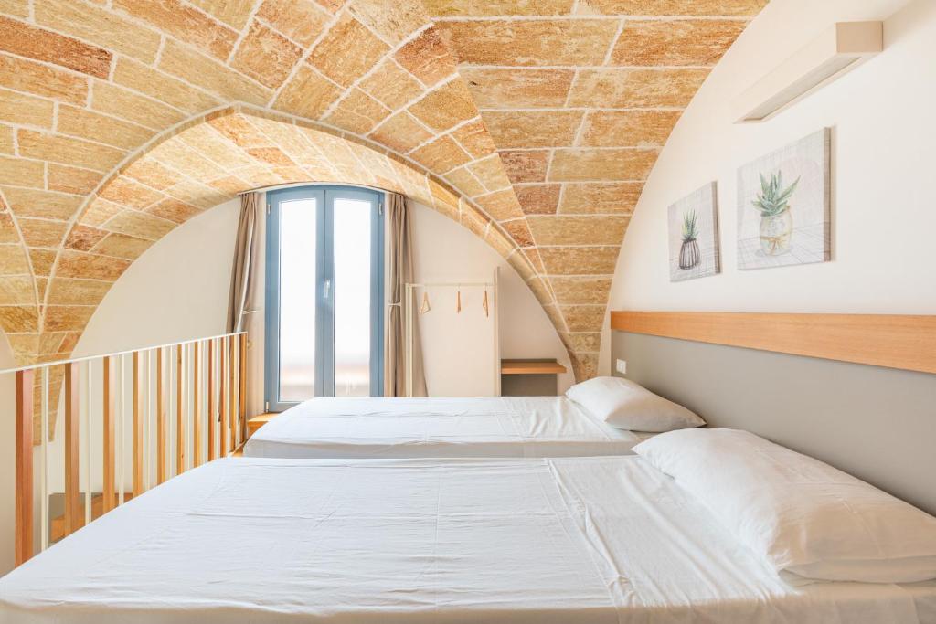 Postel nebo postele na pokoji v ubytování La Corte Relais