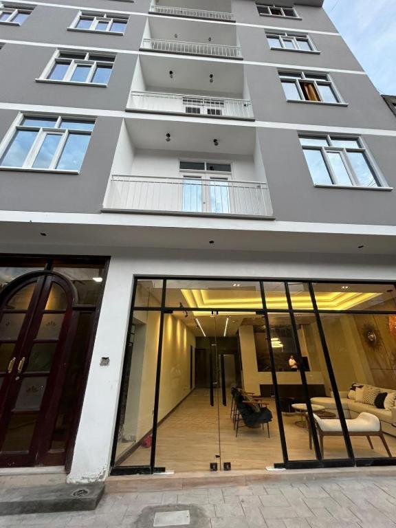 a large building with glass doors and a balcony at Hotel INTERnazionale in Ayacucho