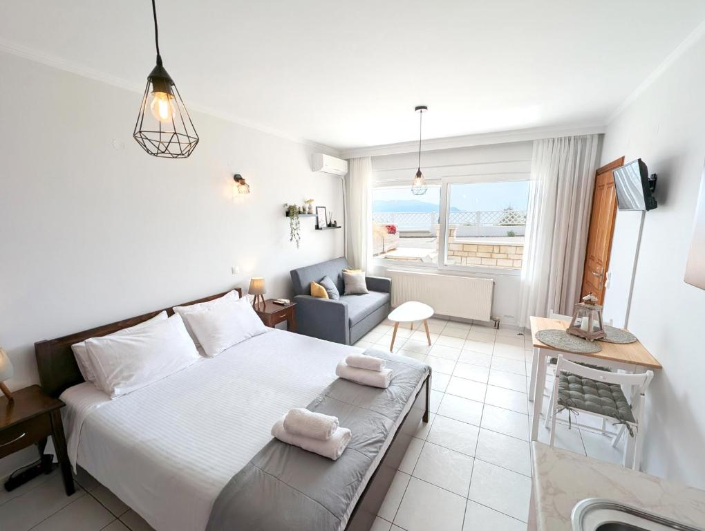 a bedroom with a bed with two towels on it at Ionian Blue Studio in Preveza