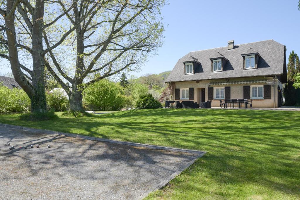 a house with a large yard with green grass at Villa de la Douloustre in Montgaillard