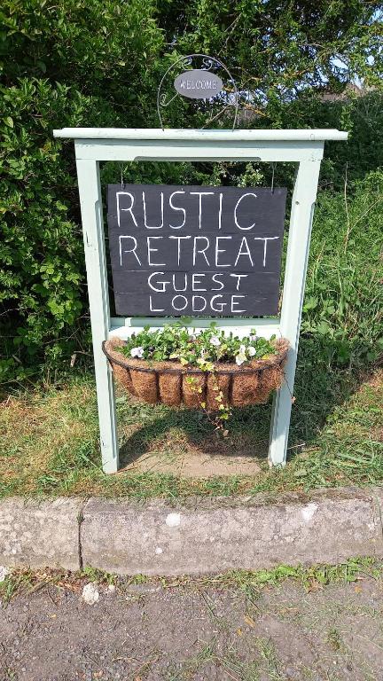 a sign for a rustic retreat guest object at Rustic Retreat Guest Lodge in Littleport