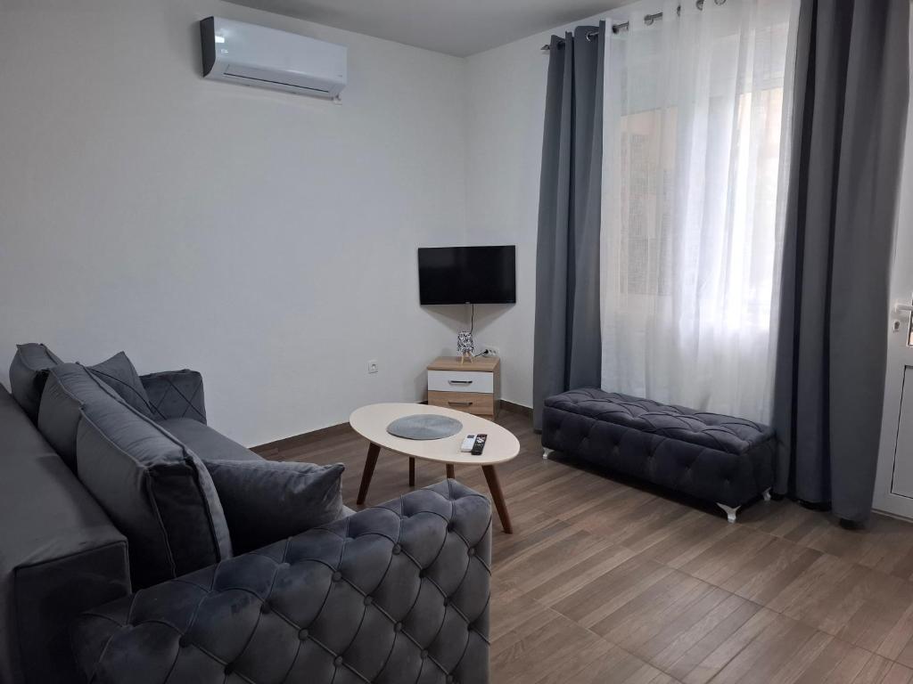 a living room with a couch and a table at Apartman Lazovic Prcanj in Kotor