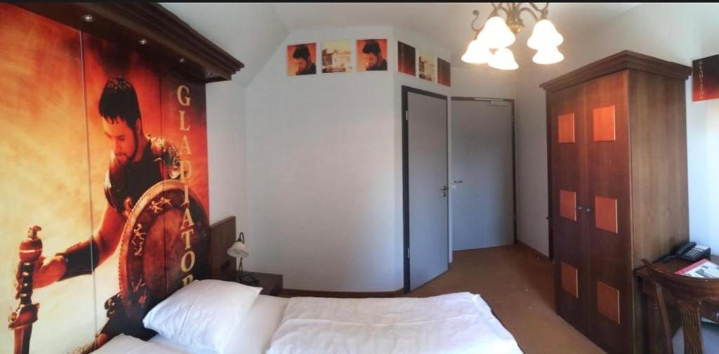 Postel nebo postele na pokoji v ubytování CineHotel Maroni
