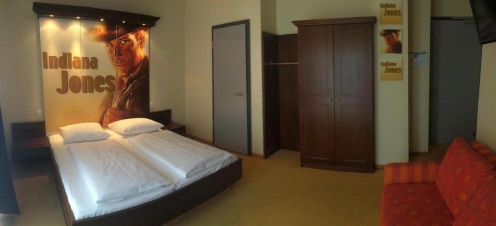 Postel nebo postele na pokoji v ubytování CineHotel Maroni