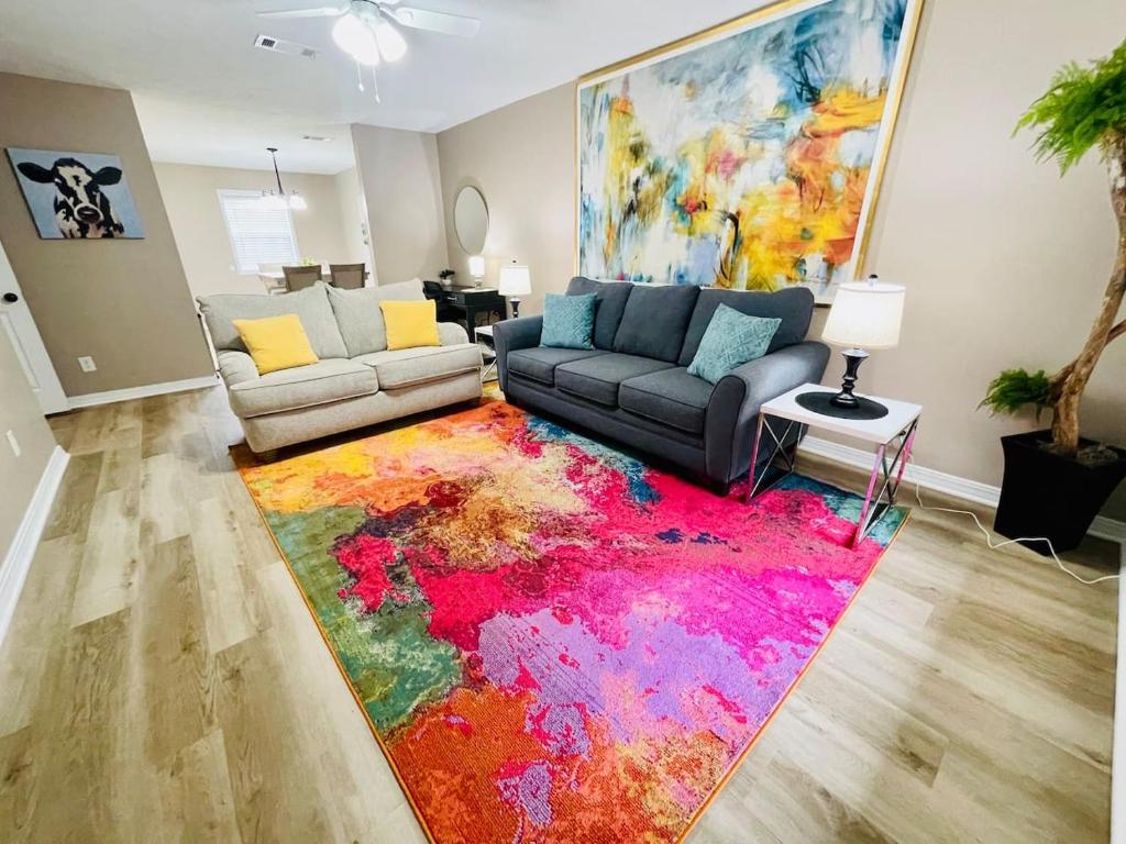a living room with a colorful rug on the floor at Eastgate 18A beautiful townhouse in Hammond
