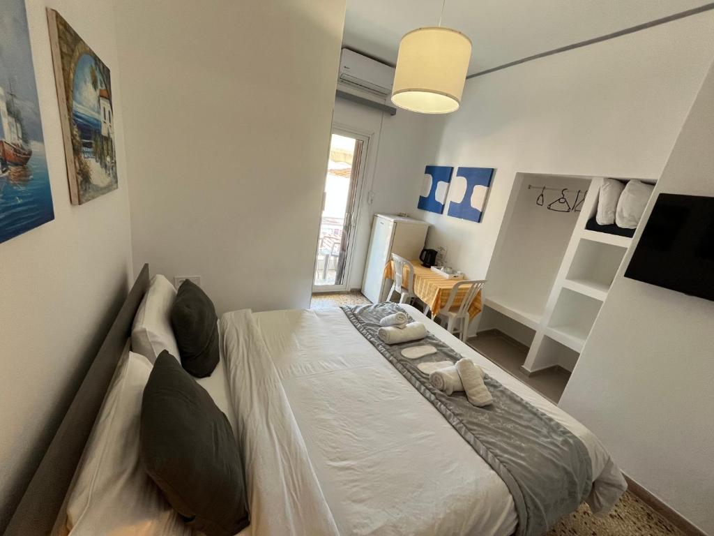 a bedroom with a bed with shoes on it at Sunset view Rooms in Agia Triada
