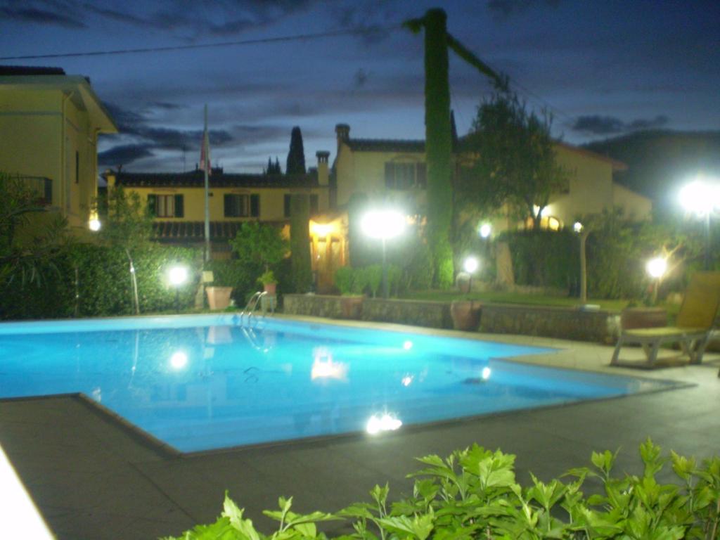 a swimming pool in a yard at night at Chiardiluna in Pistoia