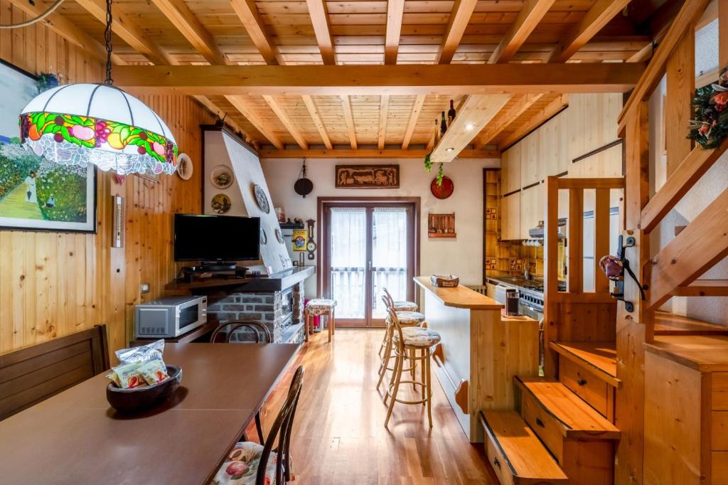 una cocina con paredes de madera y techos de madera. en Tonale Sky Attic - Ponte di Legno by InnStay, en Ponte di Legno