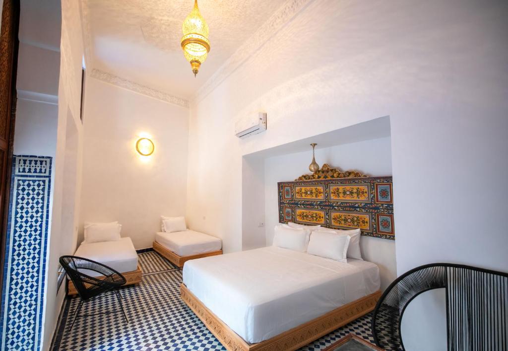 Postel nebo postele na pokoji v ubytování Riad Old City Palace