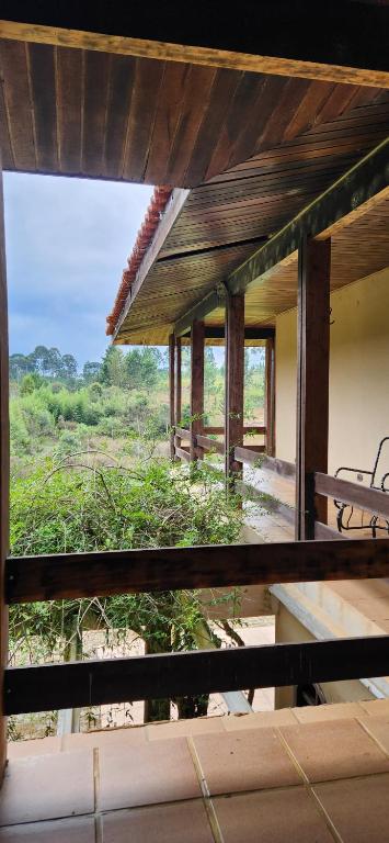 a view of a house with a view of a field at Hospedaria Soraya Alegre in Campina Grande do Sul