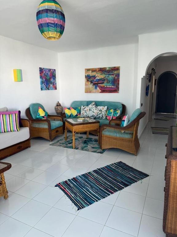 a living room with couches and a coffee table at plage al amine eden in Fnidek