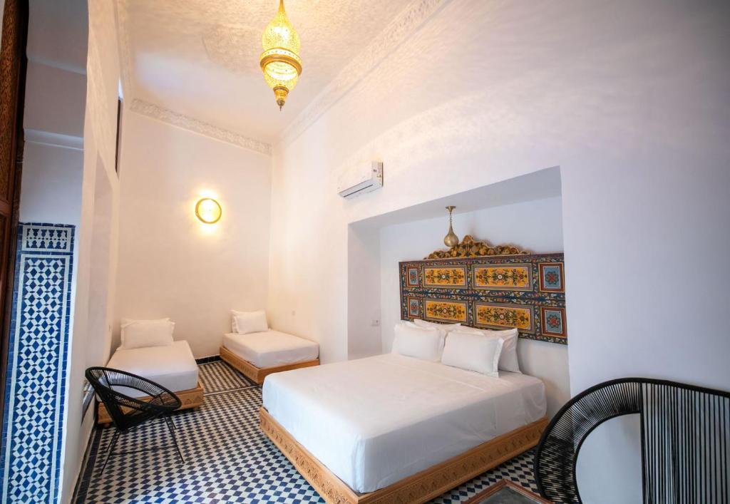 Postel nebo postele na pokoji v ubytování Riad Old City Palace