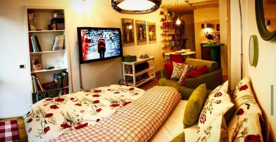 a living room with a couch and a flat screen tv at La Casetta sui tetti in Bergamo
