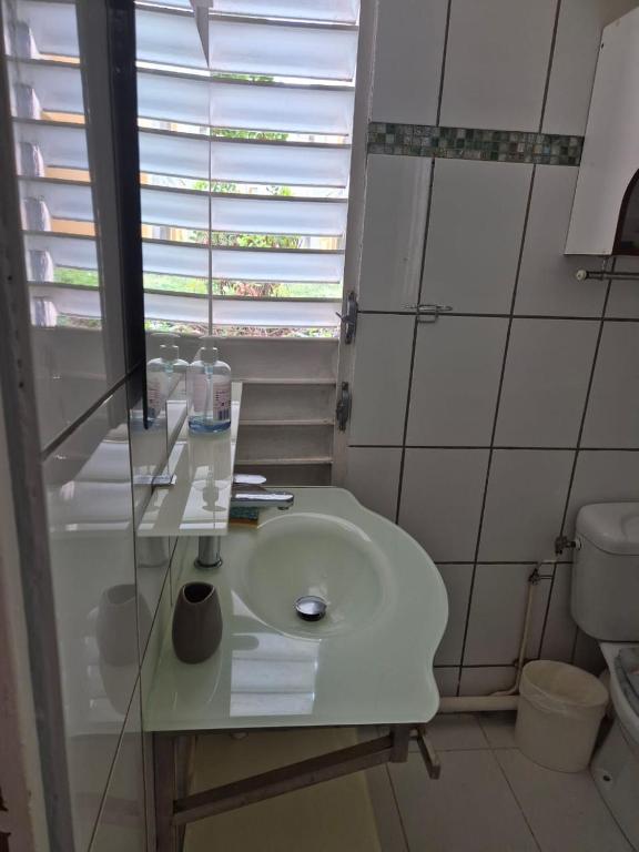 a bathroom with a sink and a toilet at Le Havre de paix in Sainte-Anne