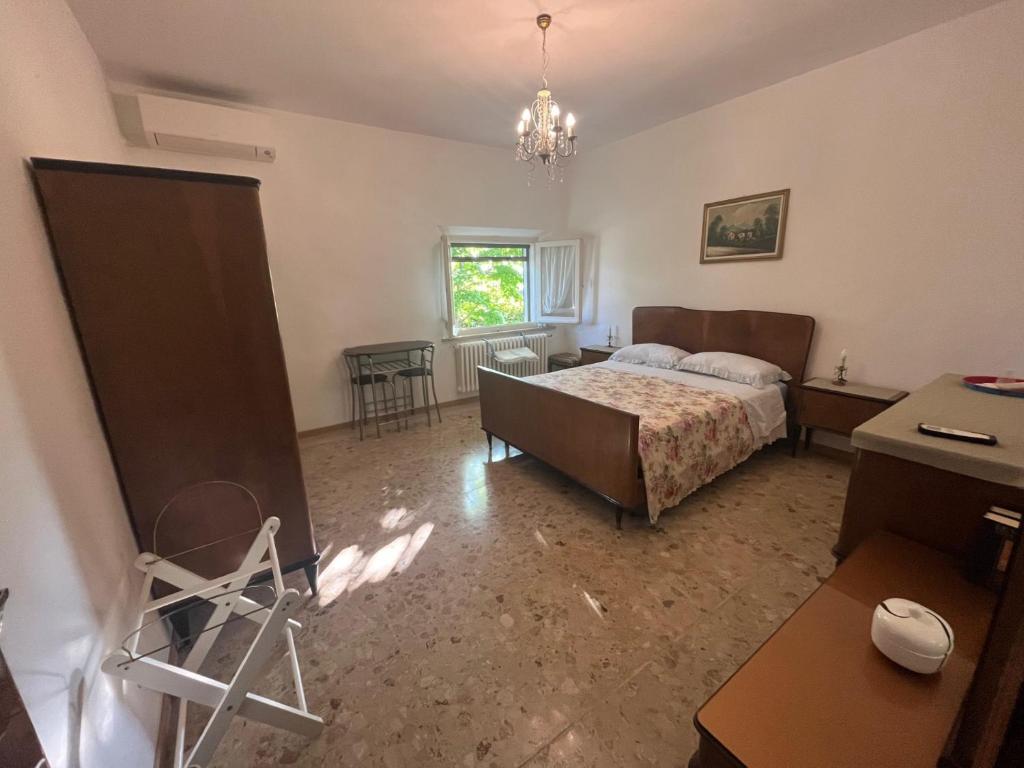 a bedroom with a bed and a table and a window at B&B Locanda Pinà - Room 2 in Montemarciano