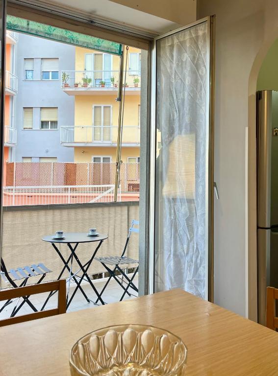 a dining room with a table and a large window at Mary's Home Cogoleto in Cogoleto