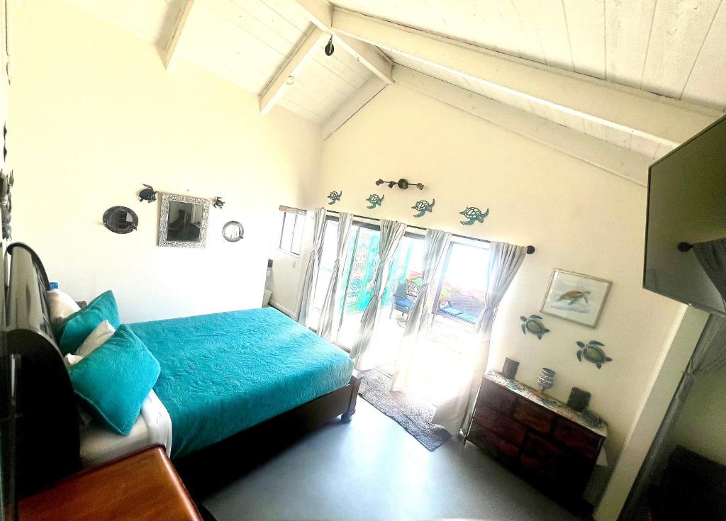 a bedroom with a blue bed and a window at Sweet Beach Duplex in Newport Beach