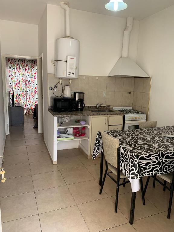 a kitchen with a table and a counter top at Almirante Brown 235 PLATA ALTA D-3 in San Martín