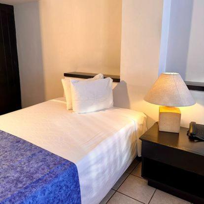 Postel nebo postele na pokoji v ubytování Hotel Delfín Vista Pier Beach Front