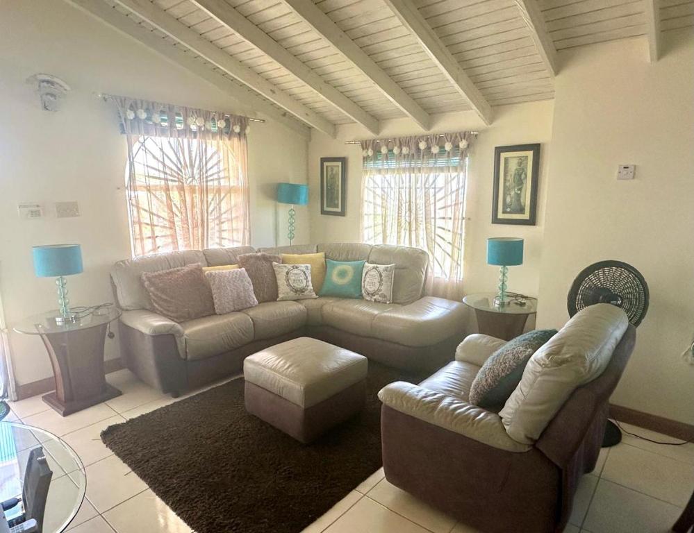 a living room with a couch and a table at Spring Top Cottage in Falmouth