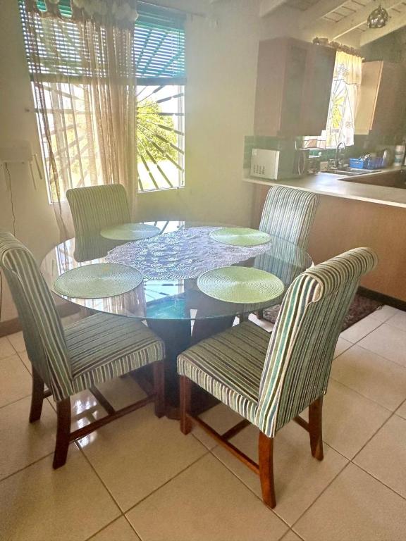 a dining room table and chairs in a kitchen at Spring Top Cottage in Falmouth