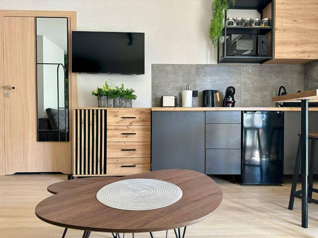 a kitchen with a wooden table and a wooden counter at Jungle Apartment in Krakow