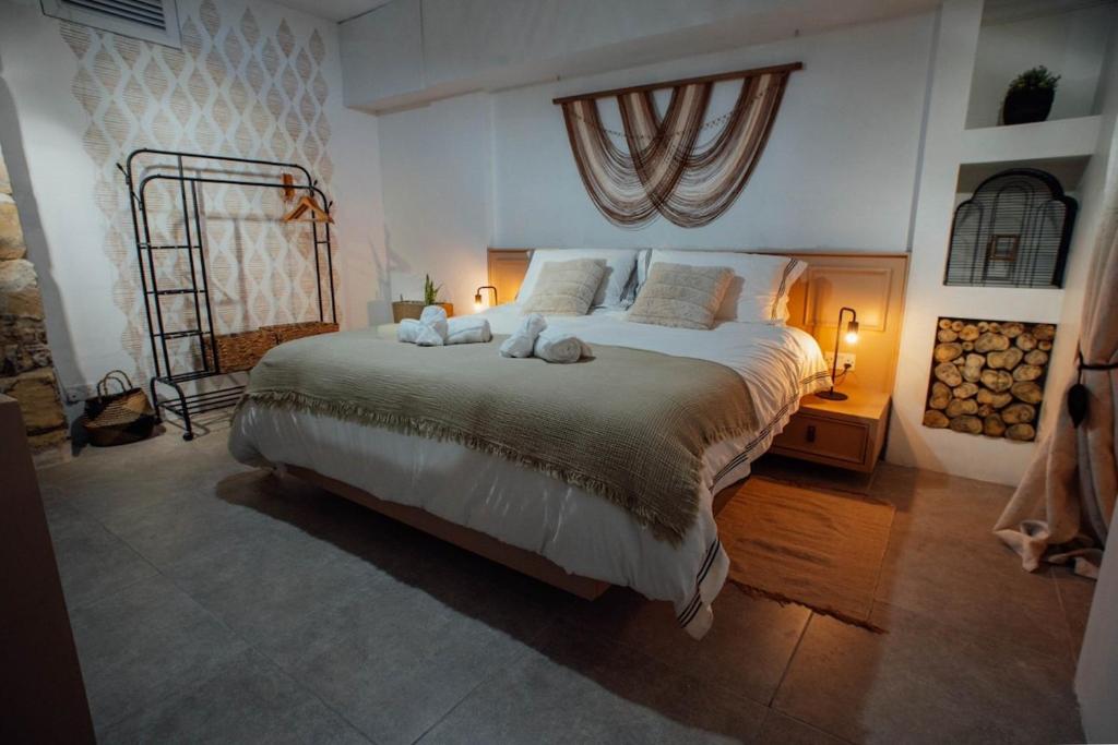 a bedroom with a large bed with two stuffed animals on it at Senglea town house in Senglea