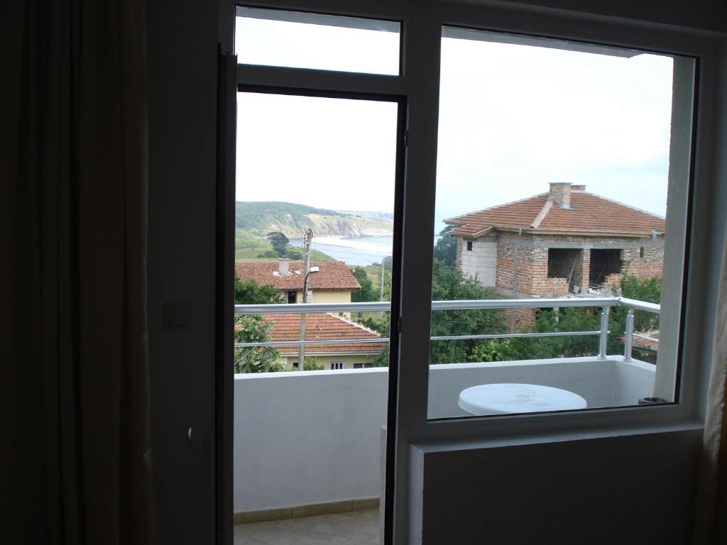 an open door to a balcony with a view of the ocean at Prestige in Sinemorets