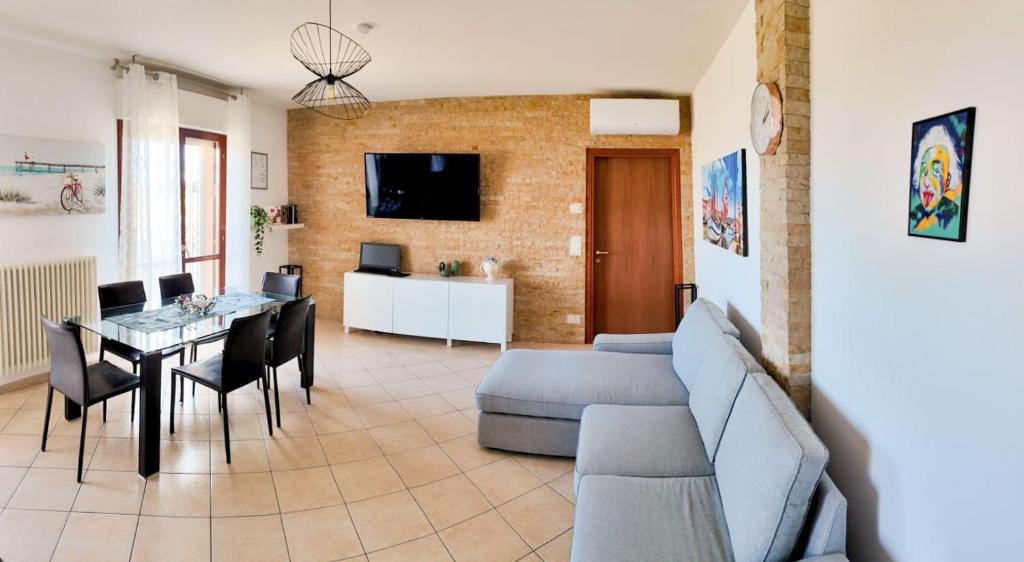 a living room with a couch and a table at Casa Plac Appartamento Panoramico- Relax Garantito in Gatteo