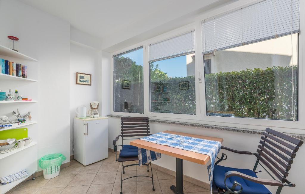 a kitchen with a table and two chairs and a window at Guesthouse Casa Nova in Poreč
