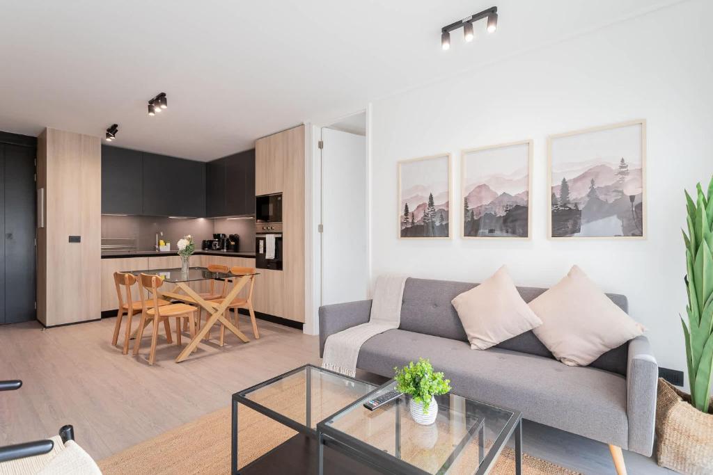 a living room with a couch and a table at Enjoy the Space 2BR 2BA Parque Araucano Sector in Santiago
