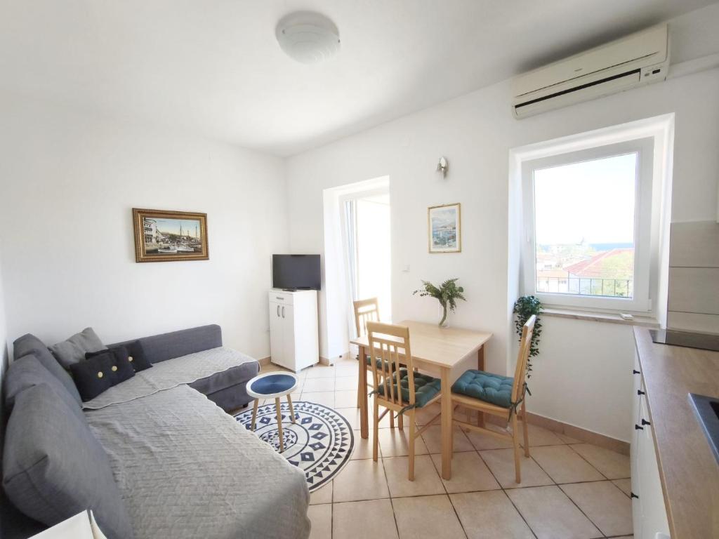 a living room with a couch and a table at City apartment Rina in Crikvenica