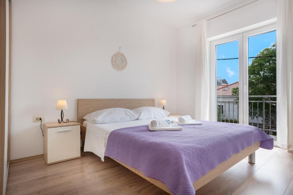 Postel nebo postele na pokoji v ubytování Apartments A&A