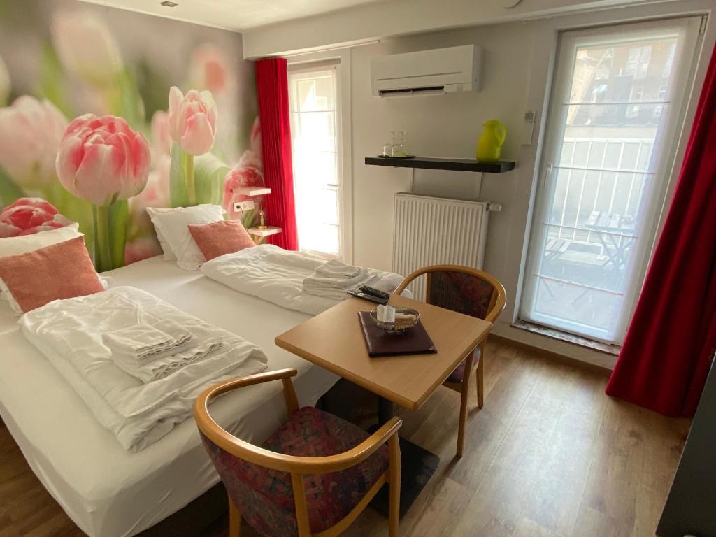 Postel nebo postele na pokoji v ubytování Hotel De Backer