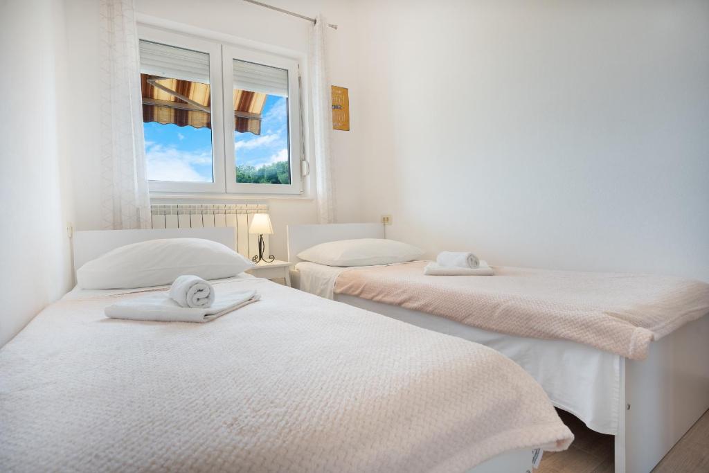 Postel nebo postele na pokoji v ubytování Apartments A&A