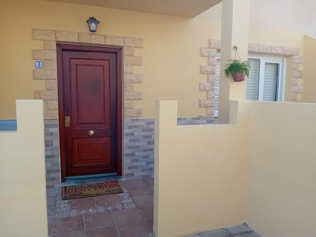 a red door on the side of a house at Hawaii house in Puerto del Rosario