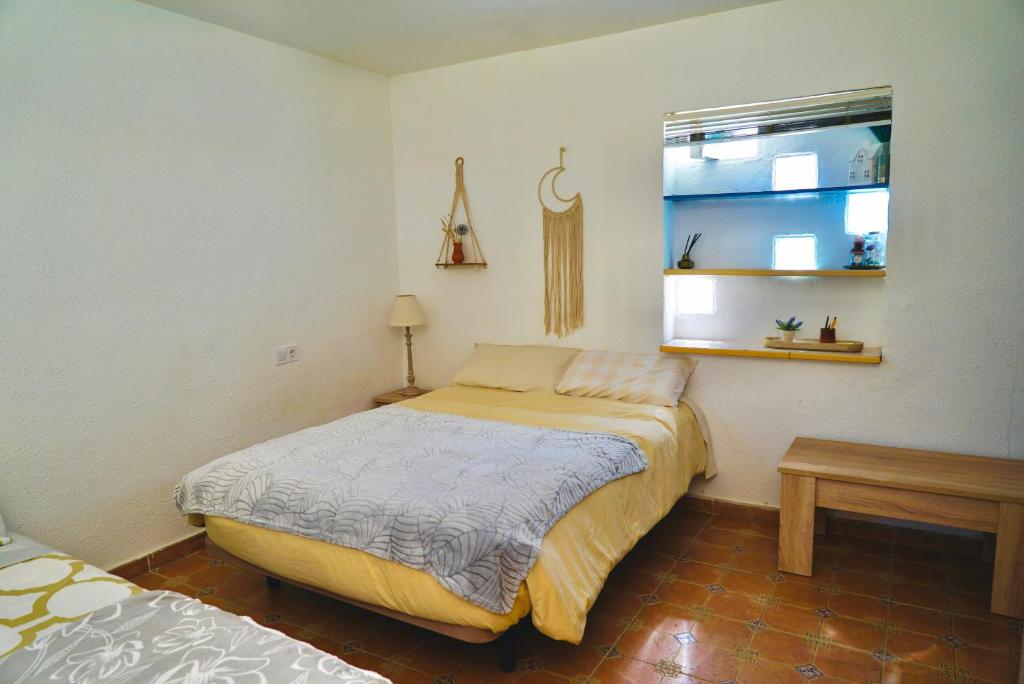 a small bedroom with a bed and a window at Alicante Garden & BBQ - Estudio adosado con Jardín, Parking Privado y Relax Total in Alicante